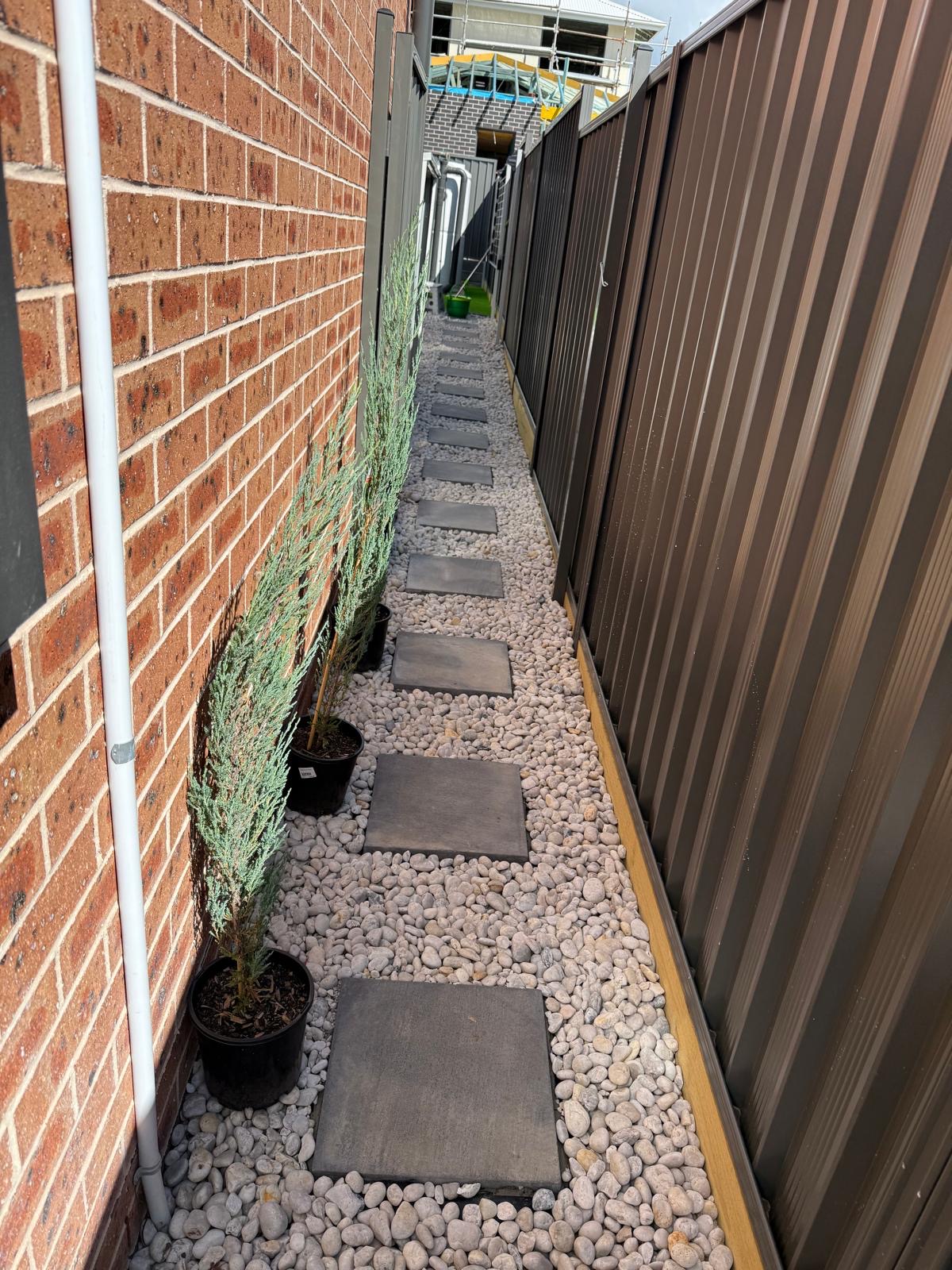 Garden paving and softscaping Sydney - sandstone pavers meeting lush buffalo turf lawn